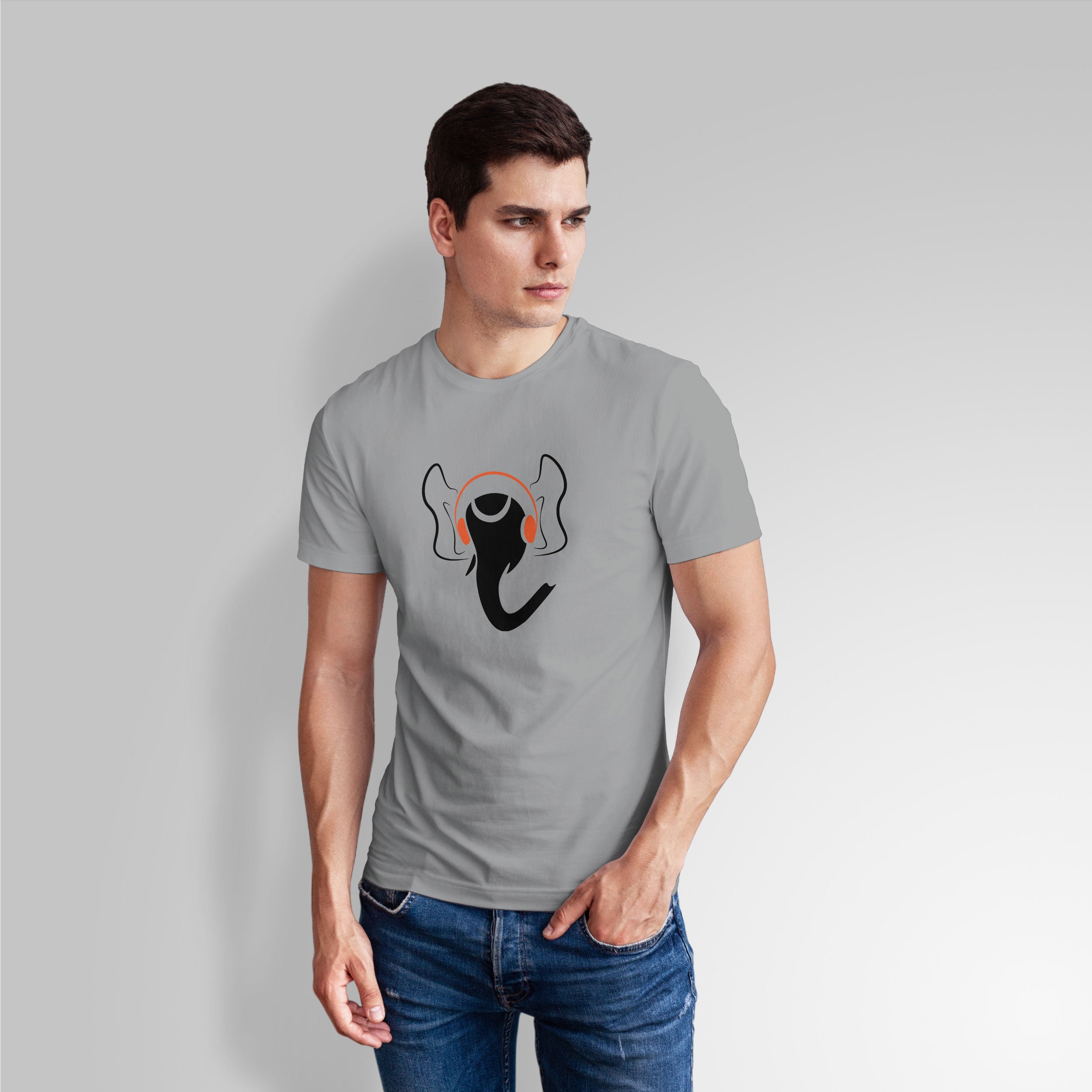 Man wearing a gray t-shirt with a graphic design on a plain background