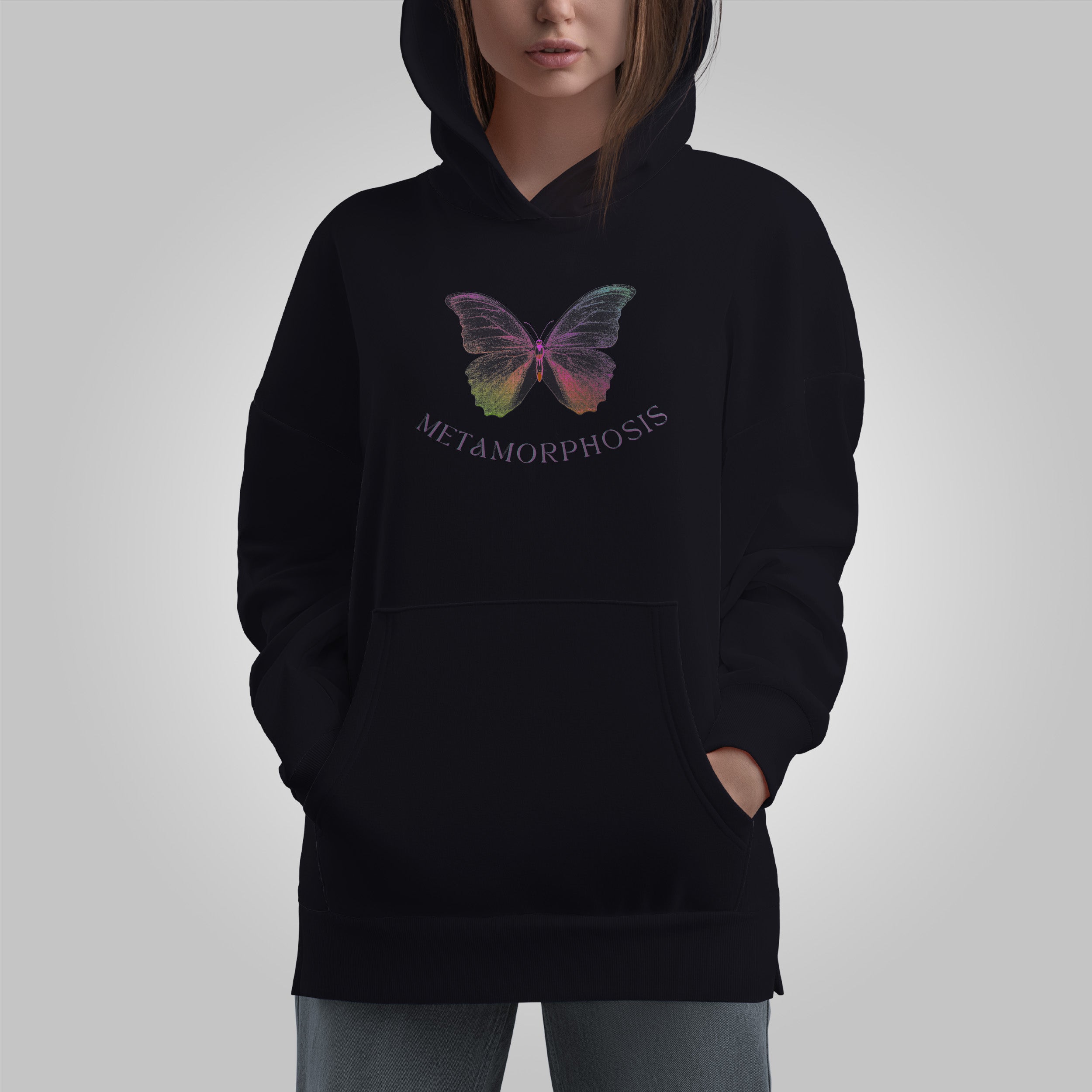 Black hoodie with a colorful butterfly design and 'Metamorphosis' text on a gray background