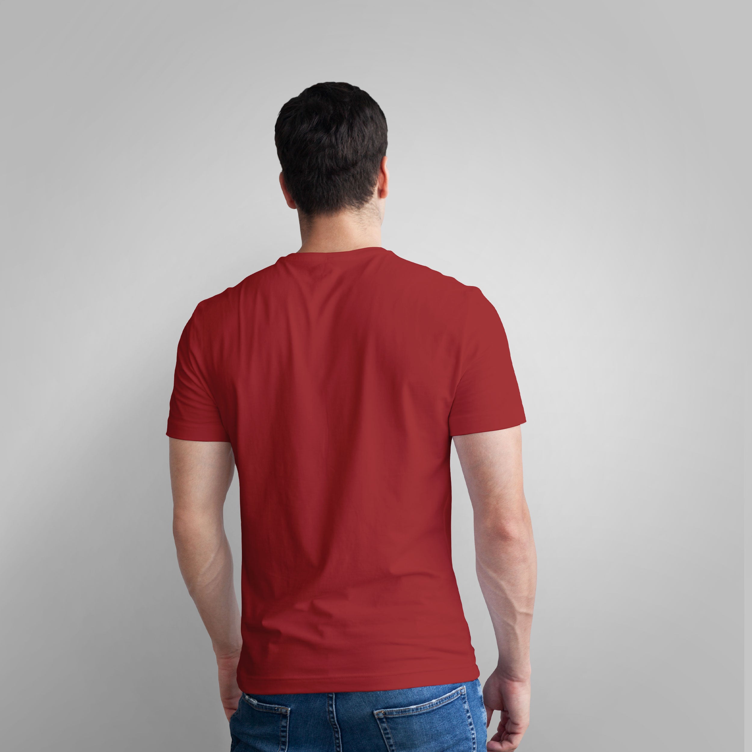 Man wearing a red t-shirt with a text graphic on a gray background
