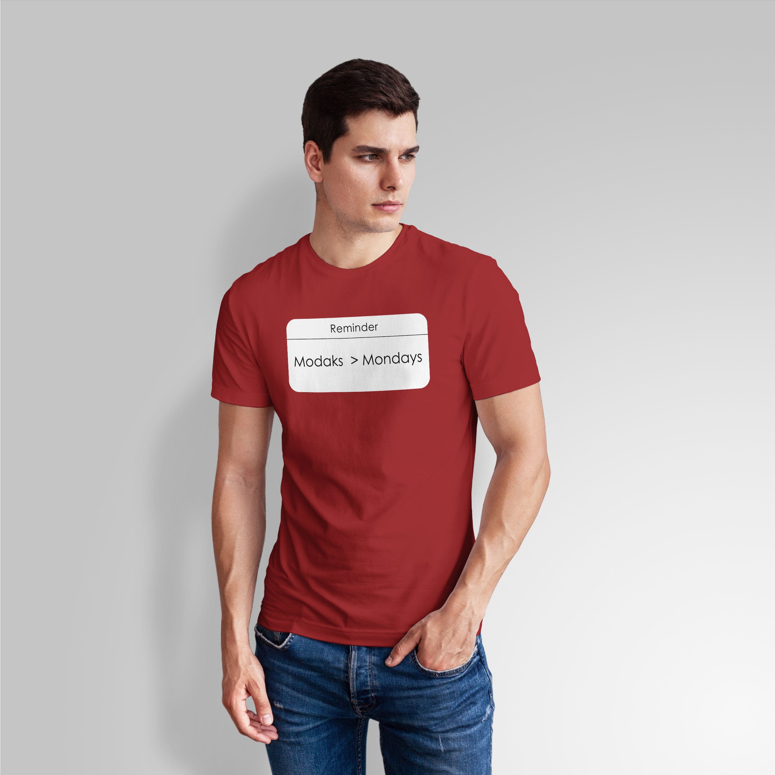 Man wearing a red t-shirt with a text graphic on a gray background